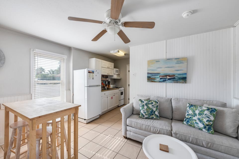 Relax in your bright, coastal-themed living space with comfy seating and a full kitchen ready for your vacation meals.