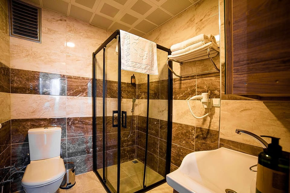 Shower, hair dryer, slippers, towels