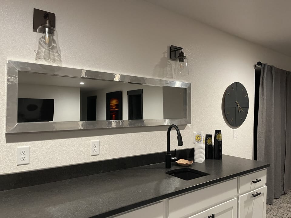 Wet bar with a ice maker and second refrigerator in the lower level family room