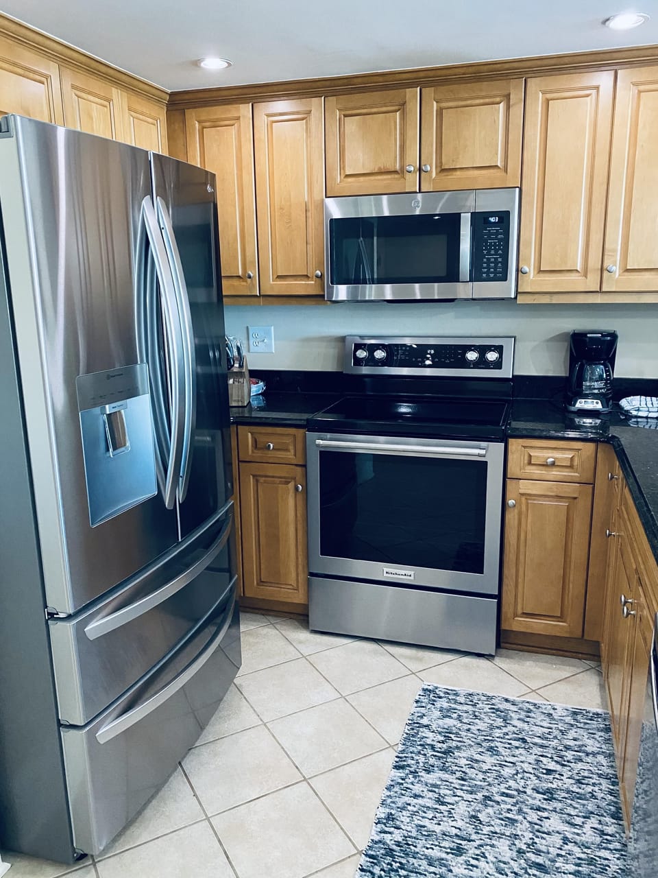 Modern kitchen with stainless steel appliances and warm cabinetry