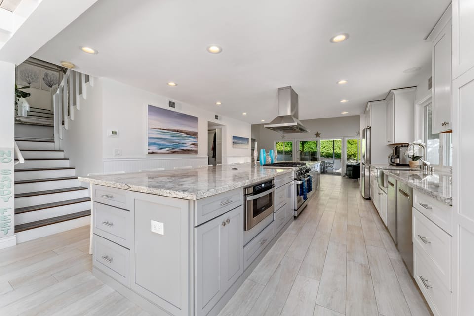 Gourmet kitchen with 20 by 5 foot granite kitchen island with seating for 10
