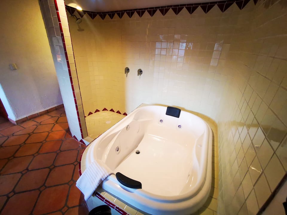 Deluxe Studio Suite (Cadbury) | Bathroom | Shower, hair dryer, slippers, towels