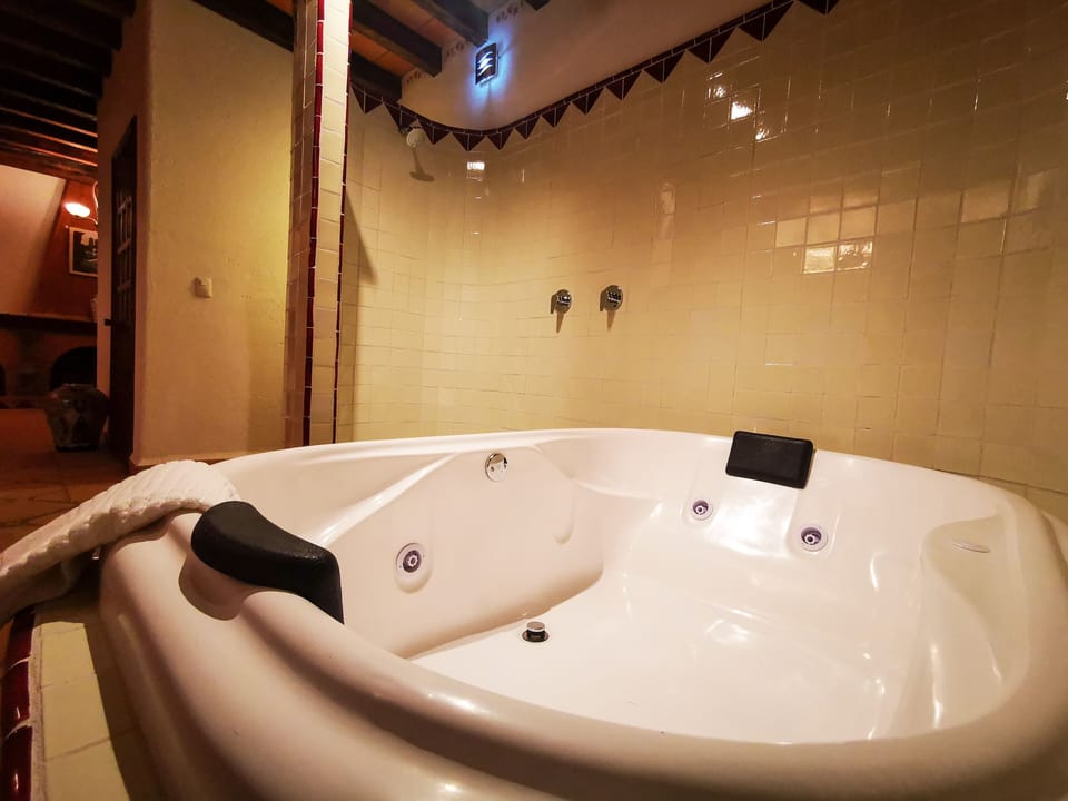 Deluxe Studio Suite (Cadbury) | Bathroom | Shower, hair dryer, slippers, towels