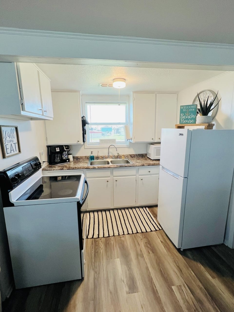Kitchen with coffee maker for both grounds and kcup.