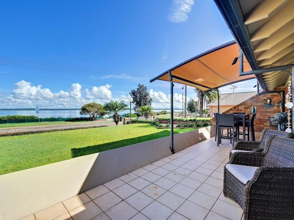 Covered balcony with outdoor bar table and chairs