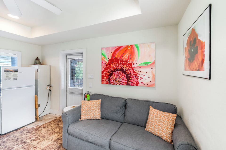 Sink into your comfortable sofa and admire vibrant artwork in this bright, thoughtfully decorated living space.