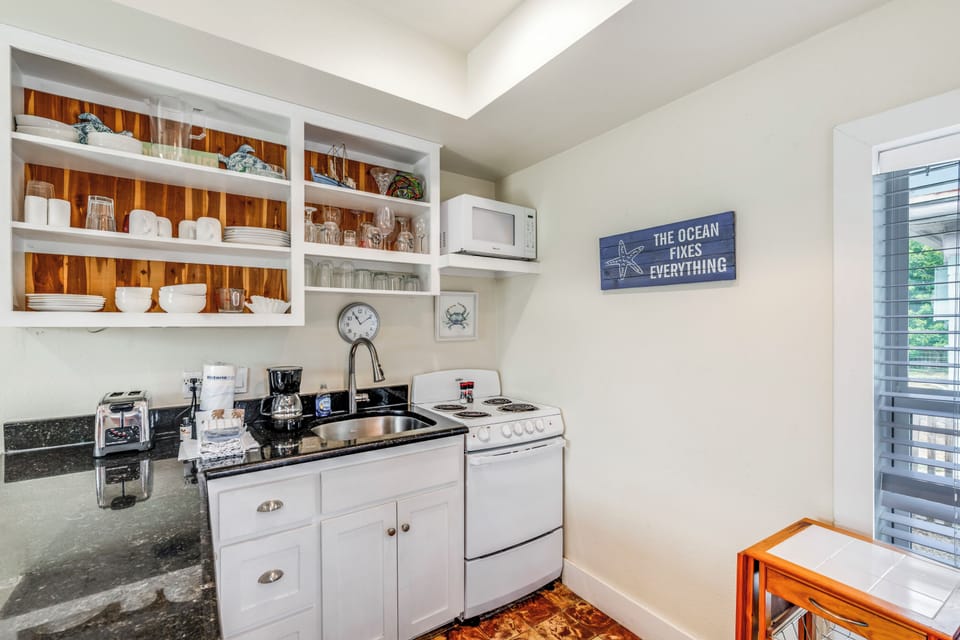 Your charming kitchenette features everything you need, from gleaming countertops to coastal decor that sets the perfect vacation mood.