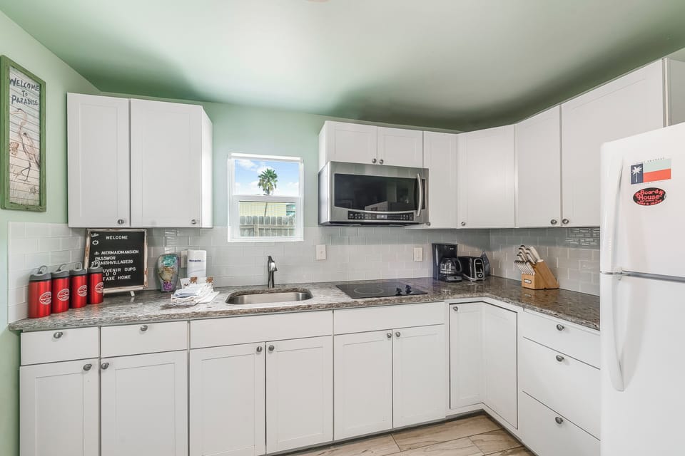 Your fully equipped kitchen awaits with granite counters, modern appliances, and everything you need to create memorable meals together.