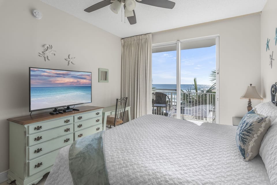 The master bedroom is bright and beachy with a King bed with new mattress, Smart TV, large closet, and bathroom with dual vanity with shower/tub combo