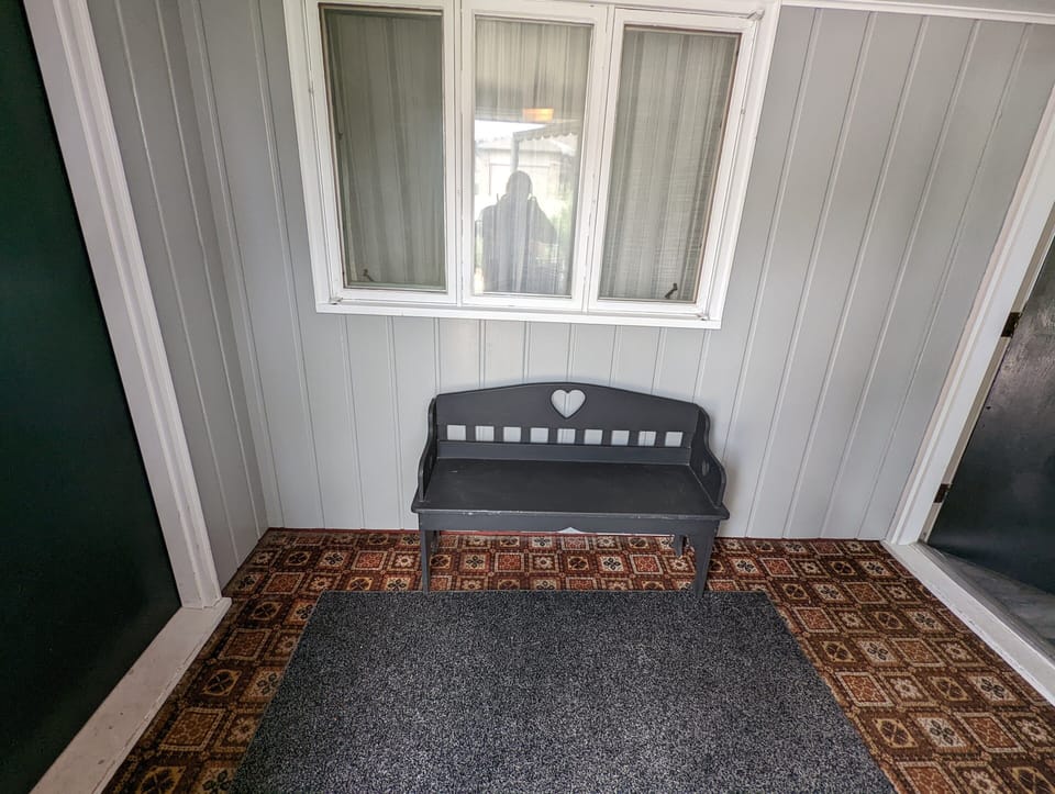 Covered Porch. Enter the home through the door on the right. 