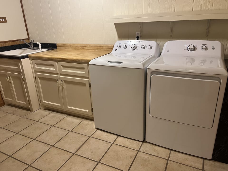 Full size washer and dryer and basement sink