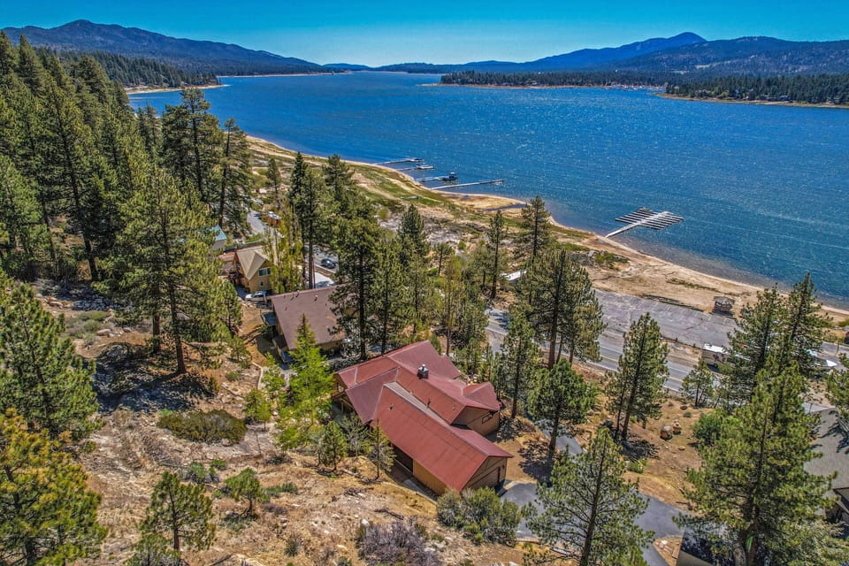 Aerial view of home with red roof looking east of the lake.