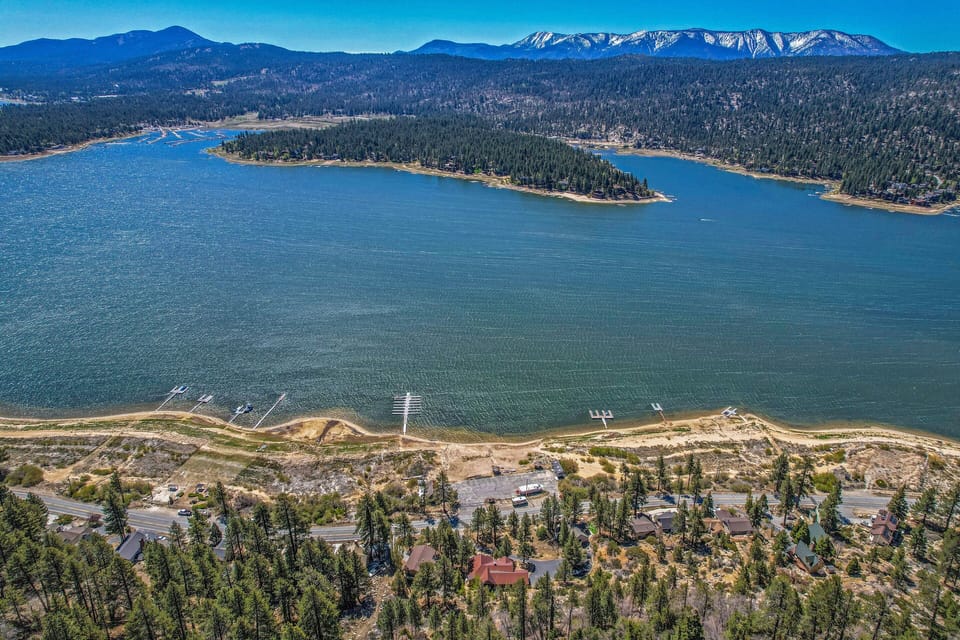 Amazing aerial view of home (red roof) with lake and mountain in front.