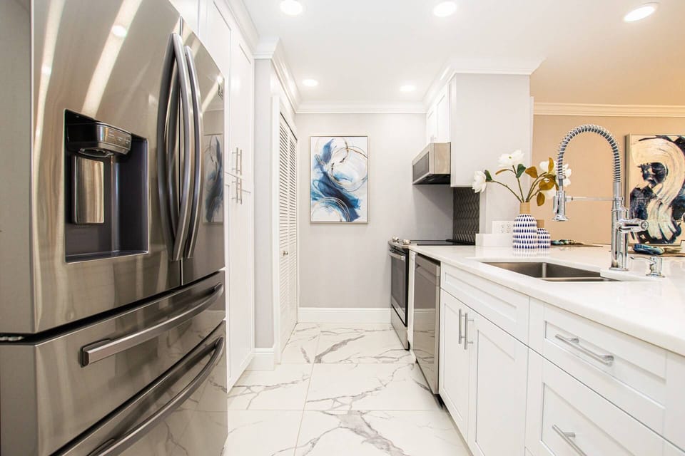 Kitchen area with all stainless steel appliances - microwave, dishwasher, range & refrigerator!