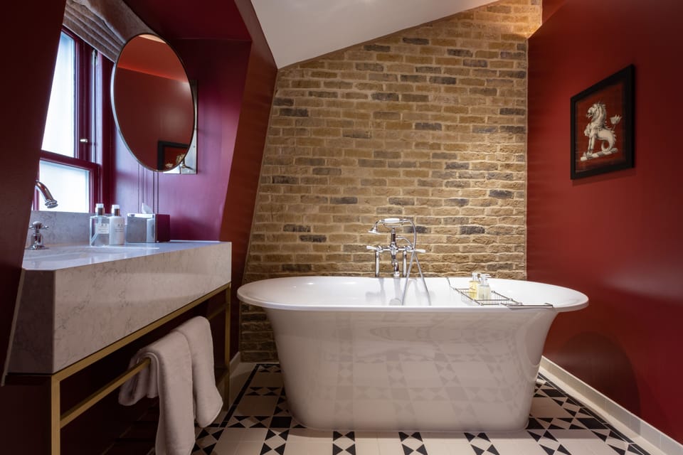 Deluxe Suite | Bathroom | Designer toiletries, hair dryer, bathrobes, slippers