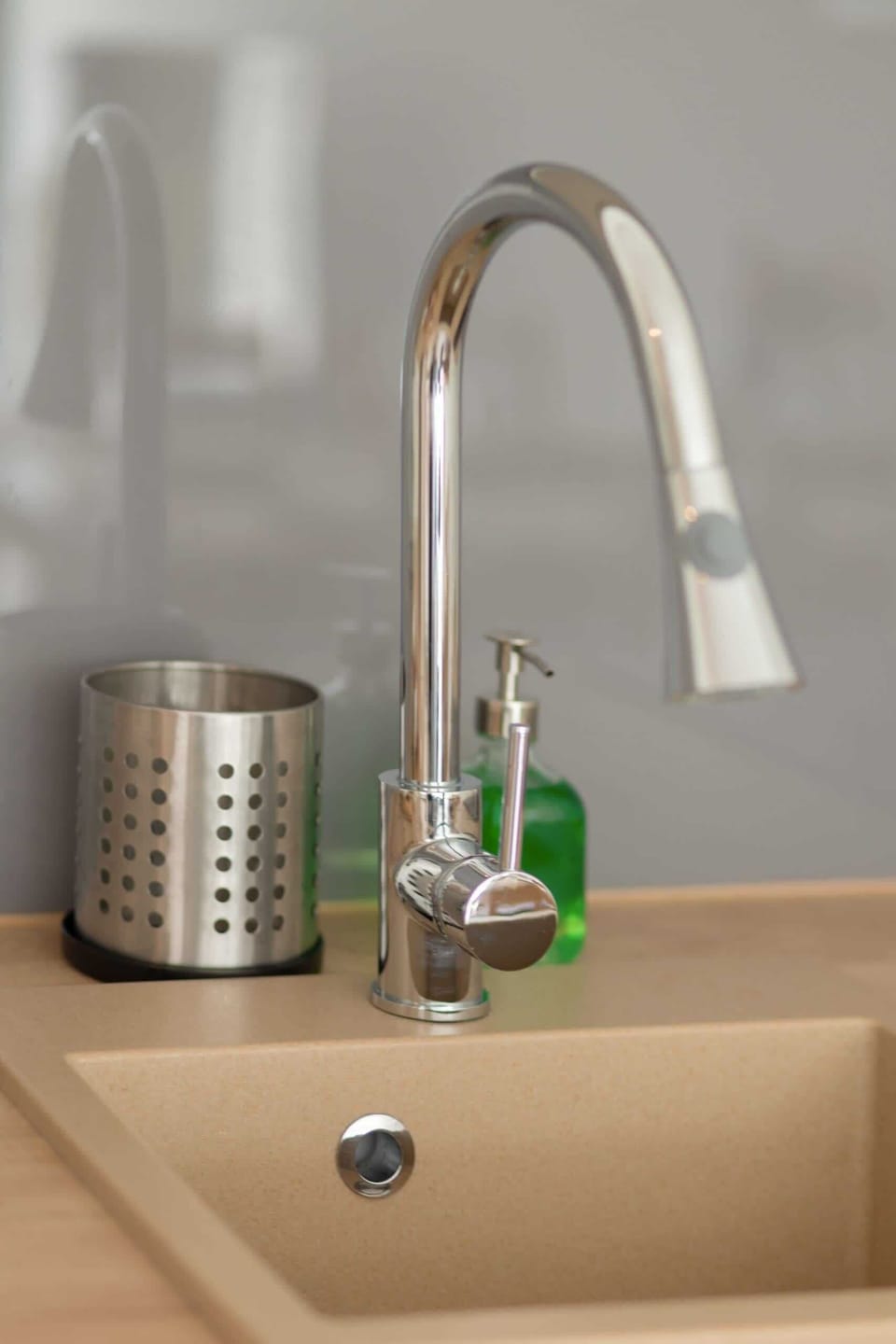 A close-up of the kitchen sink with a modern faucet, showing attention to detail in the kitchen’s design and functionality.