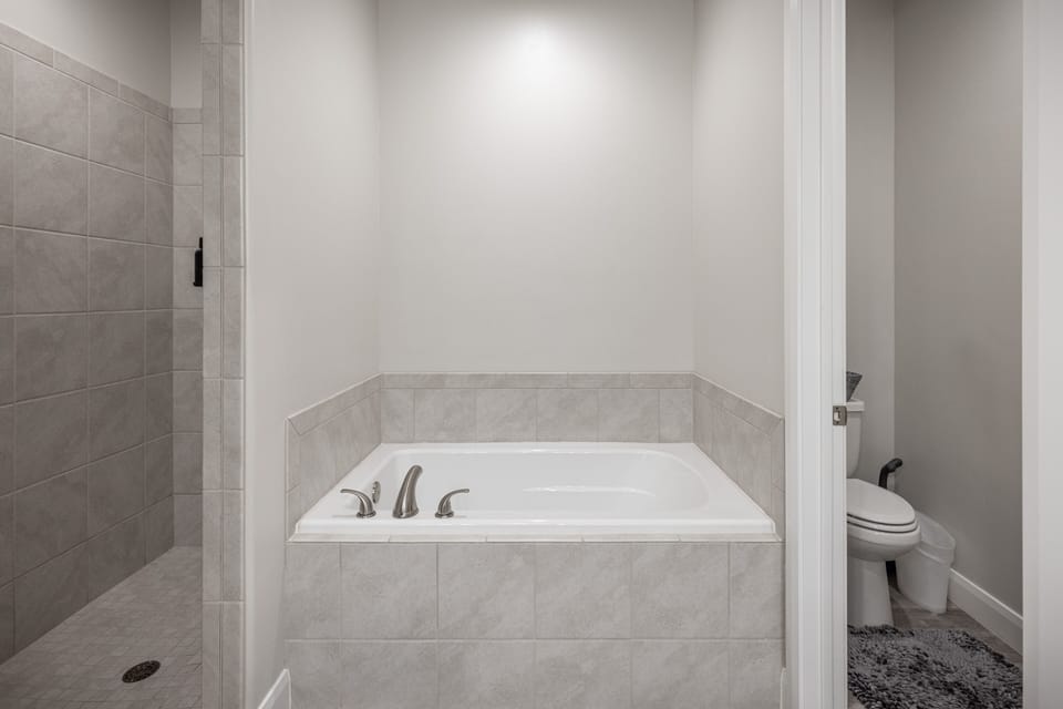 Downstairs Main Tub & Walk-in Shower - your worries soak away while relaxing in the large main bathtub and spacious walk-in shower.