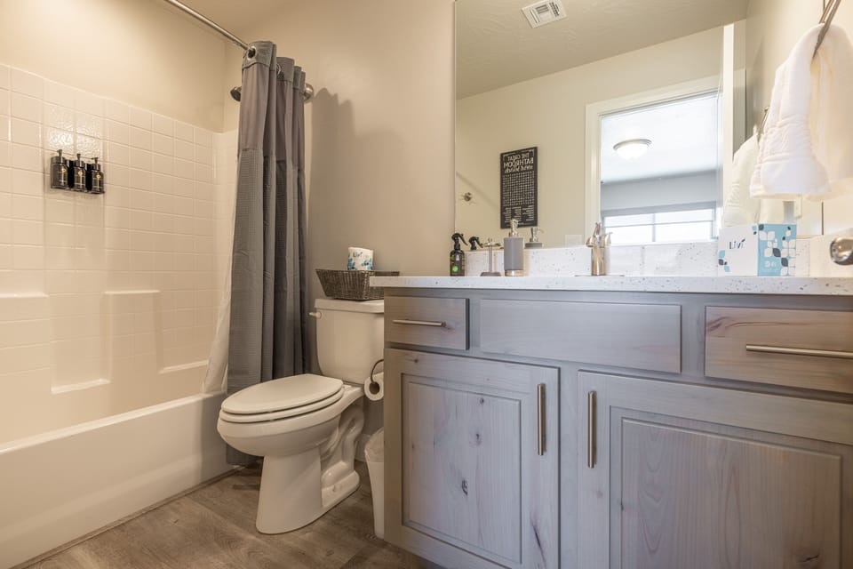 Bathroom 2 - Bathroom 2 includes a tub/shower combo, sink, toilet, and vanity.