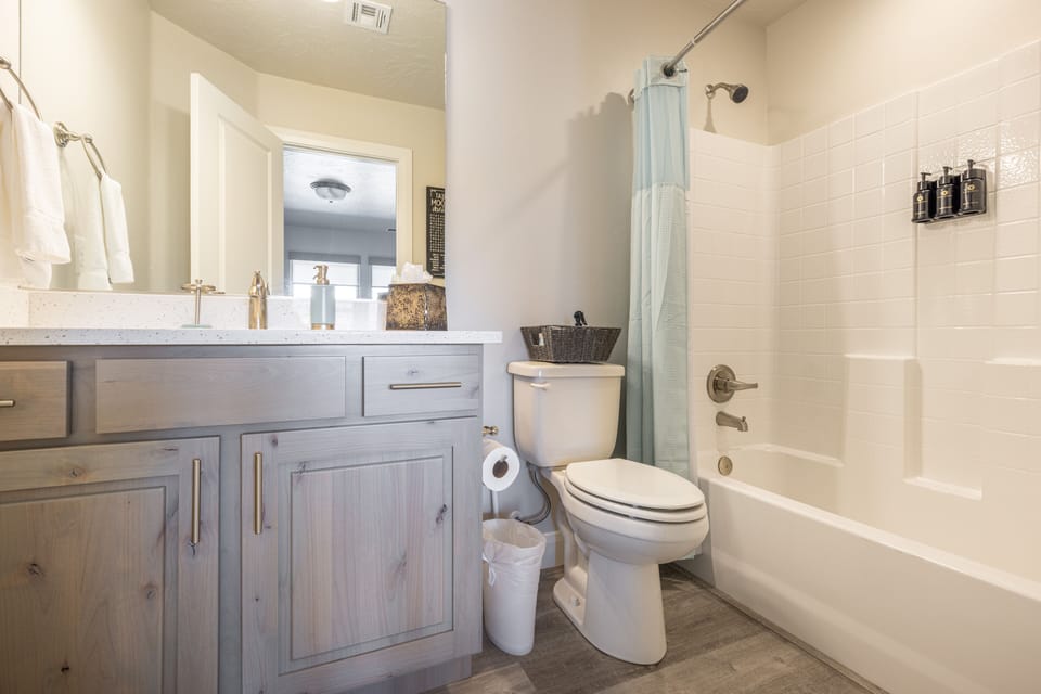 Bathroom 3 - Bathroom 3 includes a tub/shower combo, sink, toilet, and vanity.