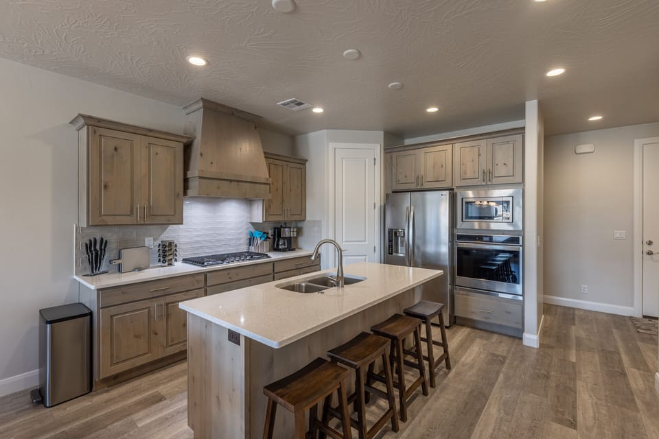 Kitchen & Kitchen Island - The Kitchen is complete with everything you will need for meal preparations including pots, pans, baking dishes, plates, cups, silverware, cutlery, and an assortment of cooking utensils.