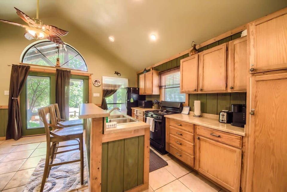 Fully Stocked Kitchen with seating for two at the coffee bar. 