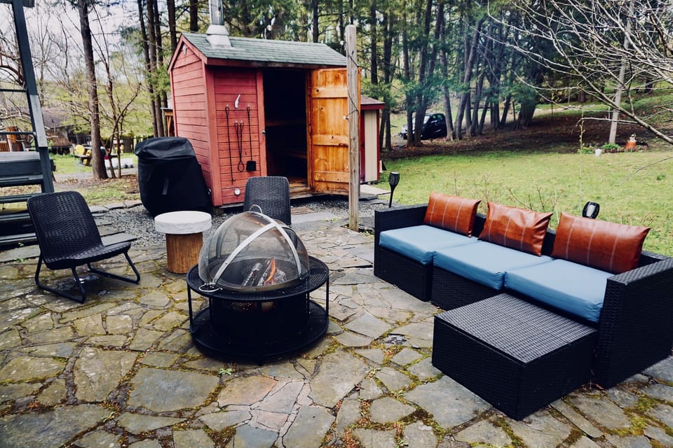Back patio with wood burning sauna, fireplace, propane grill and comfortable seatings