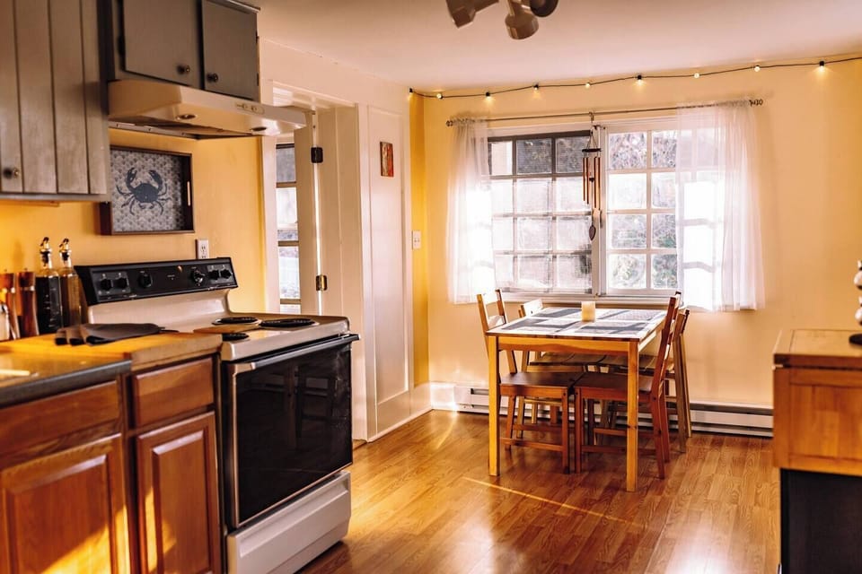 Kitchen and dining area with four chairs.