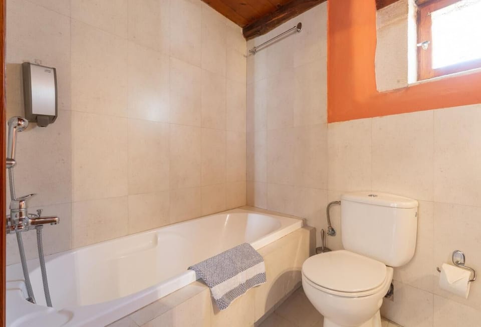 En suite bathroom with bath and shower