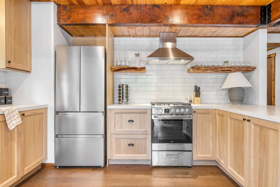 Spacious kitchen with gorgeous open shelving and modern appliances.