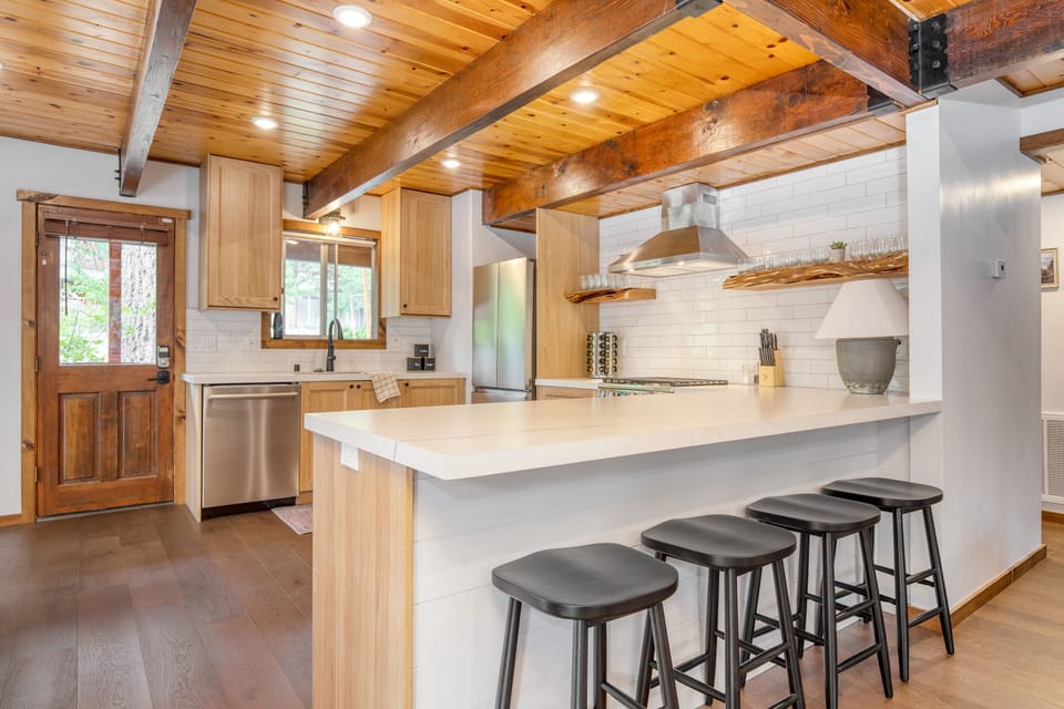 Additional barstool seating at the kitchen counter.