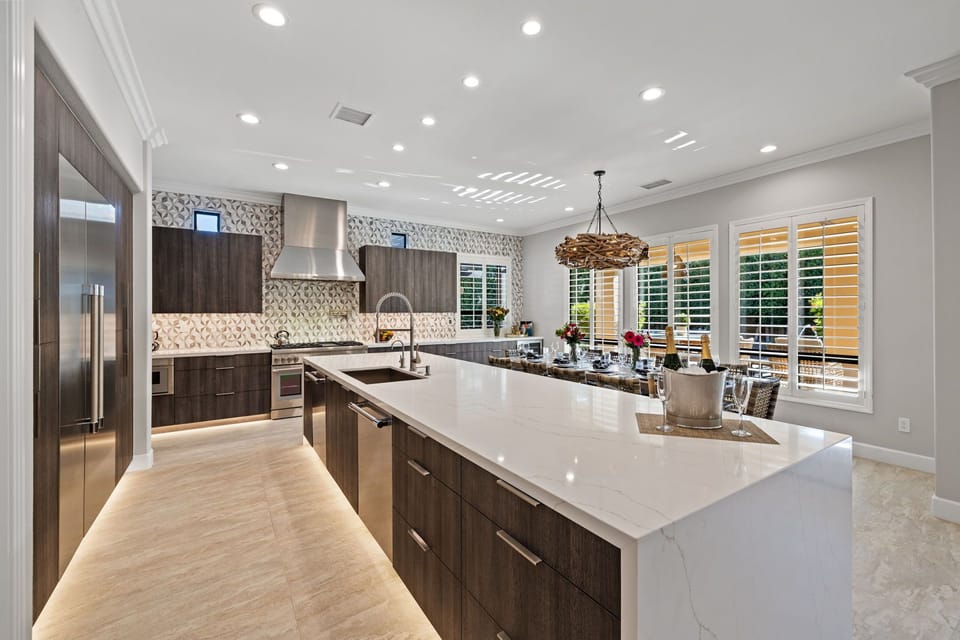 The kitchen is a chef's dream: Thermador refrigerator/freezer, gas range, double ovens, and two dishwashers make meal prep and clean-up a breeze.