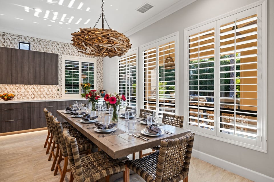 Gather for family-style meals at an expansive table in the sunlit dining area. Seating for 12.