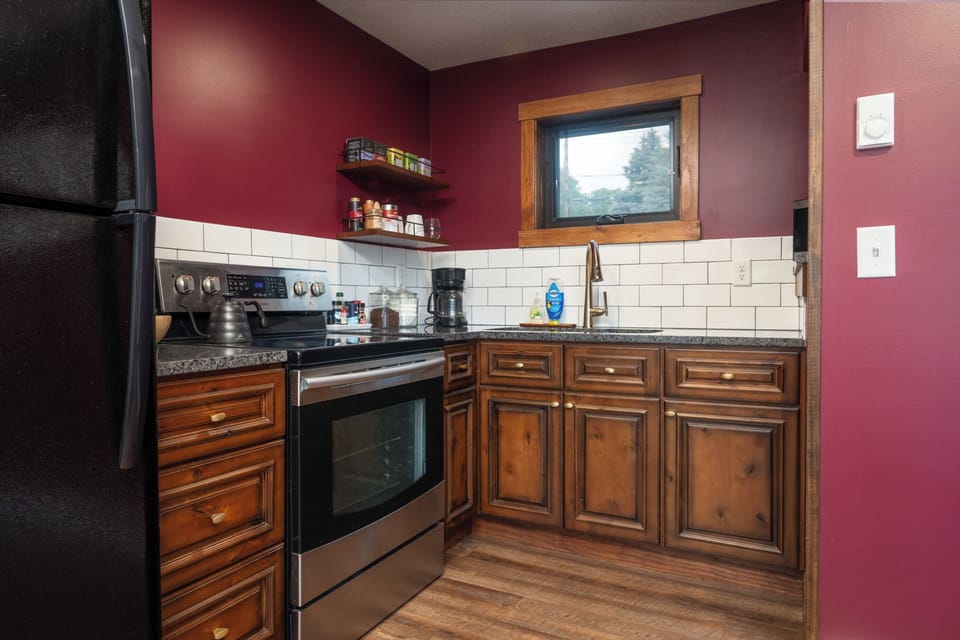 This full kitchen is stocked and ready—cookware, dishes, utensils, and even frozen pizzas for late-night cravings. Whether you're reheating leftovers or making breakfast from scratch, you’ll have everything you need just steps from the dining nook and balc