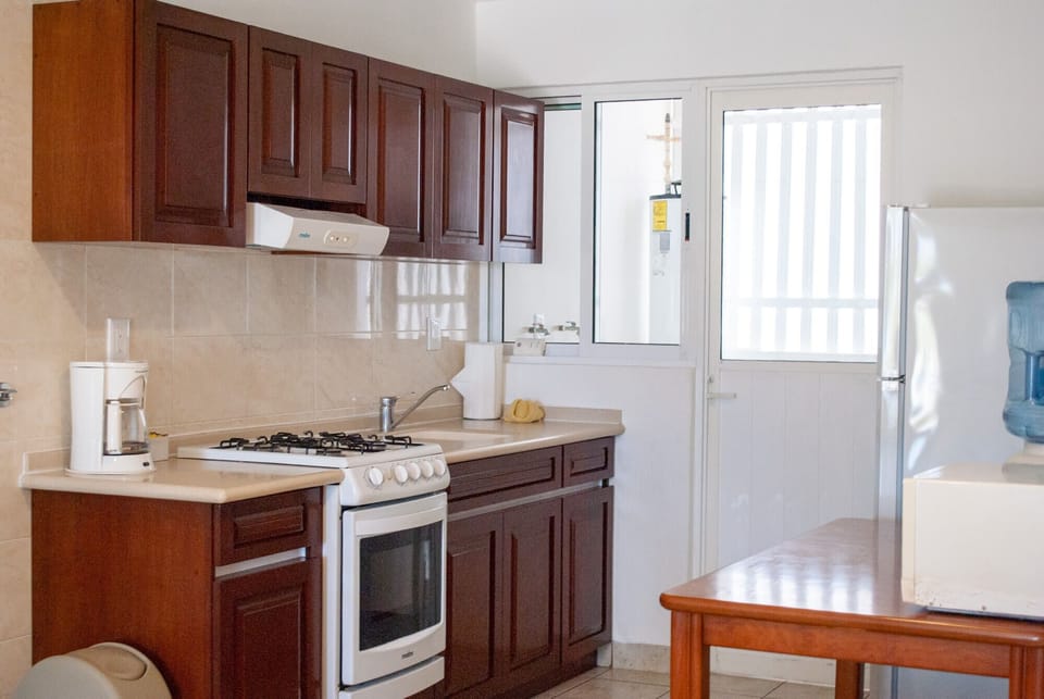 Condo, 2 Bedrooms, Ground Floor (Beachfront, 1 Bathroom) | Private kitchen | Full-size fridge, microwave, oven, stovetop