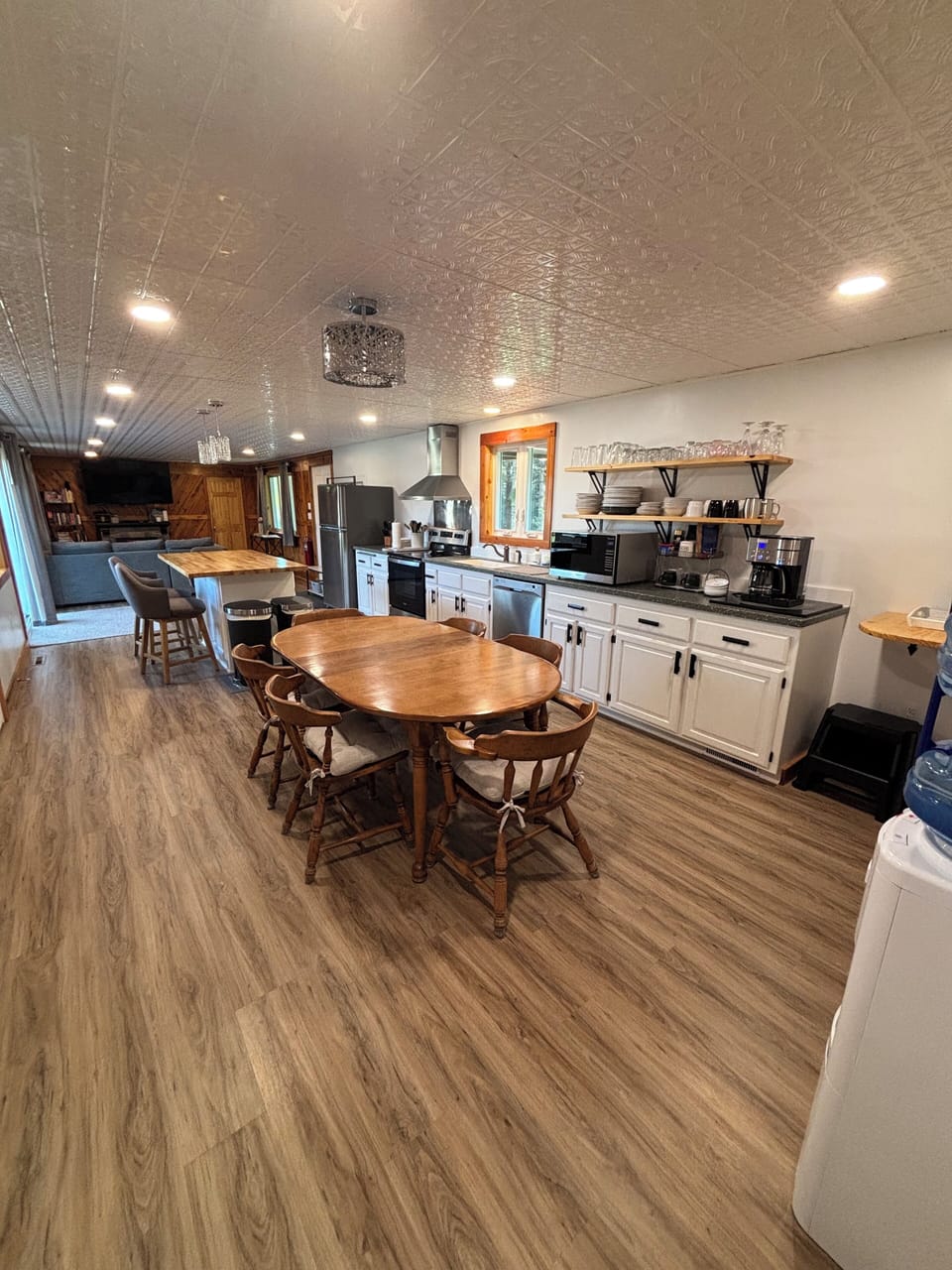 View of kitchen table seating for 6, island seating for 3
