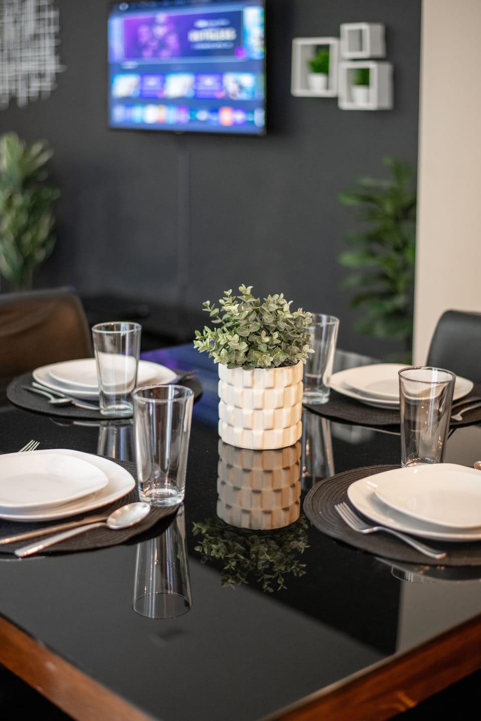 Beautiful dining table equipped with dish ware, silverware and glasses