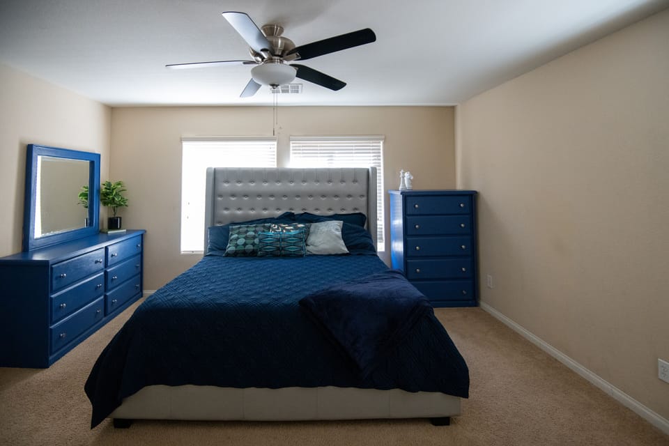 Spacious primary suite with king size bed.