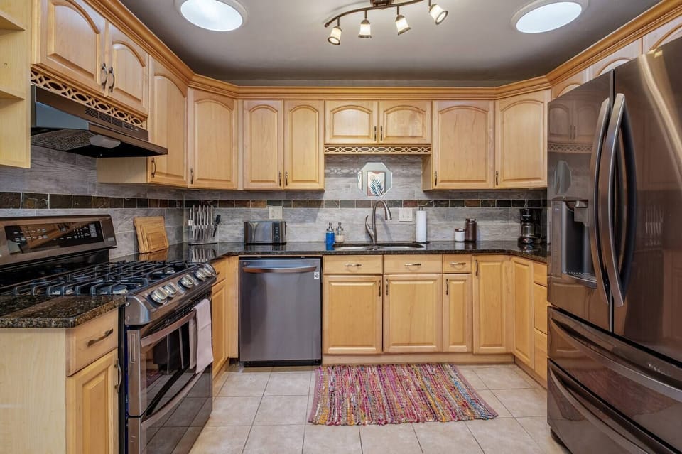 - Modern gas range, stainless steel appliances, & granite countertops
- Extra cabinet space & stylish tile backsplash make for both beauty & function
- Fully equipped with essentials, microwave, toaster, coffee maker & cutlery set for your convenienc