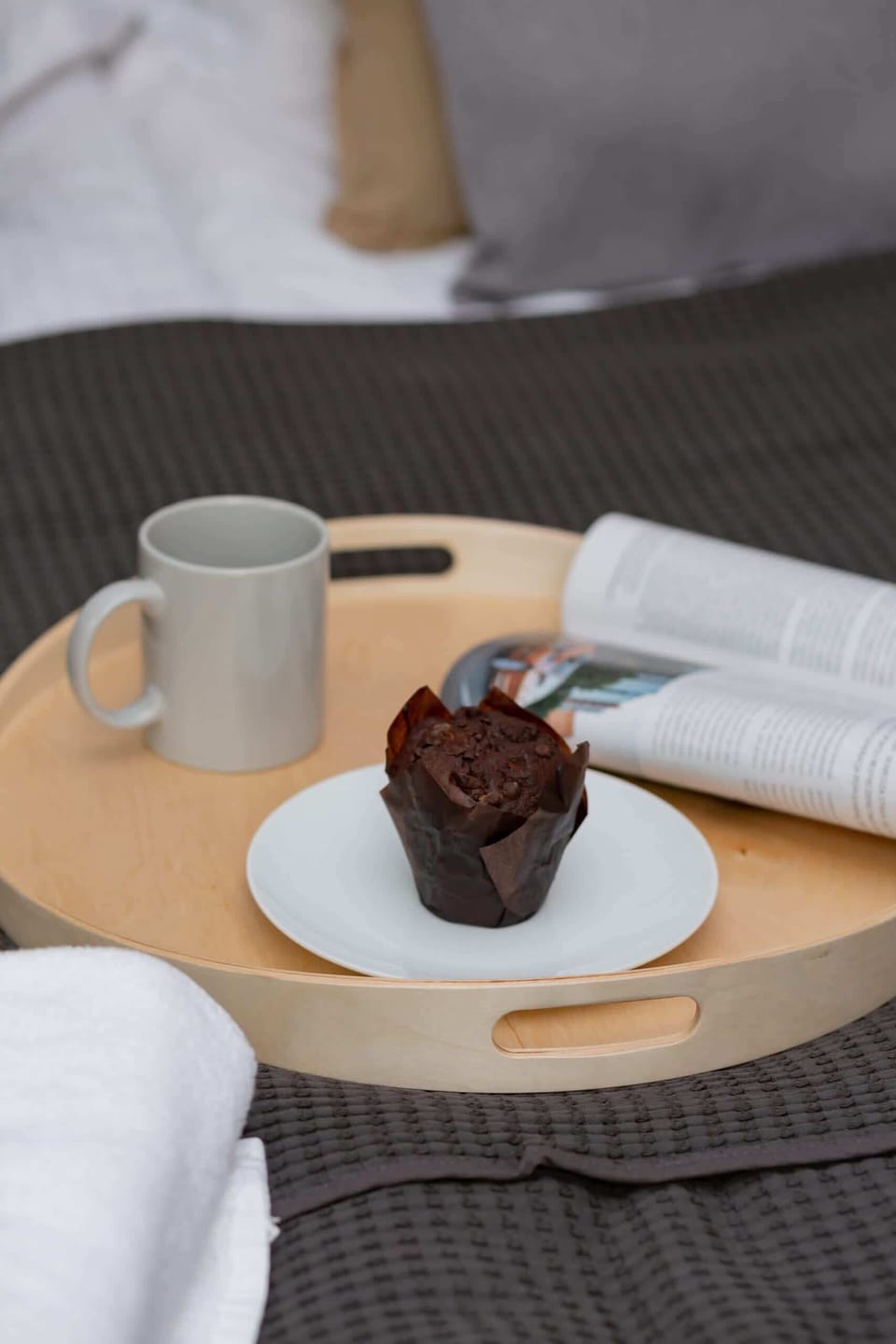 A small table with a cup of coffee and dessert is set up, giving a cozy morning vibe.