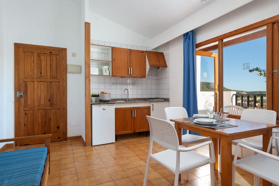 Mini-fridge, toaster, cookware/dishes/utensils, dining table