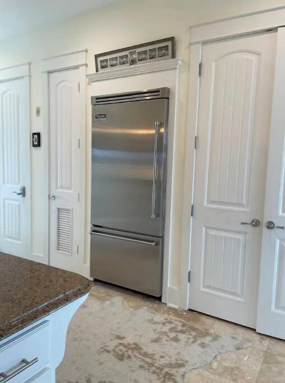 Built in Viking refrigerator adjacent to spacious pantry