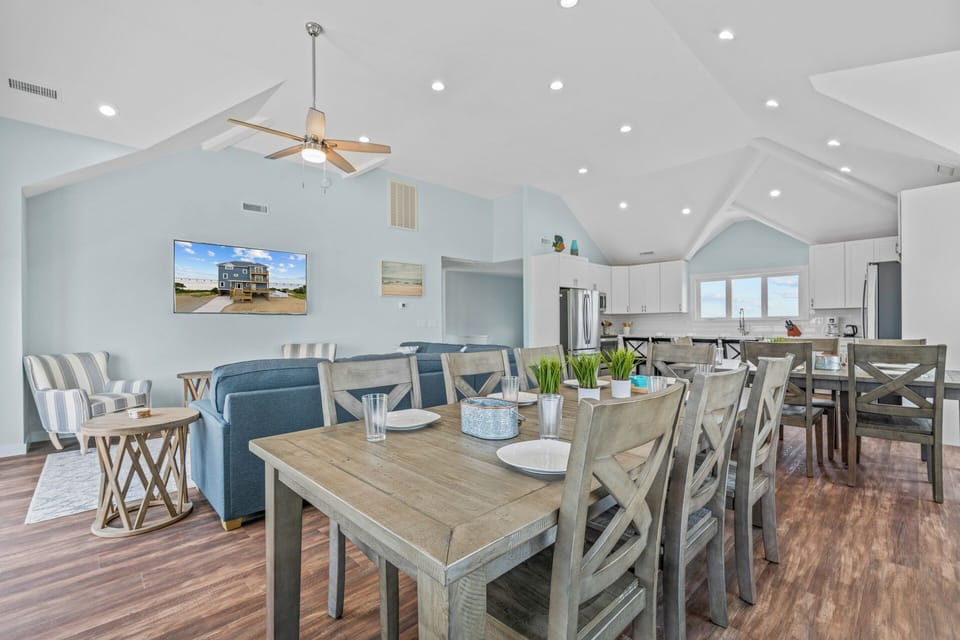 The 8-person and 6-person dining tables are directly adjacent to the 4-person breakfast counter.