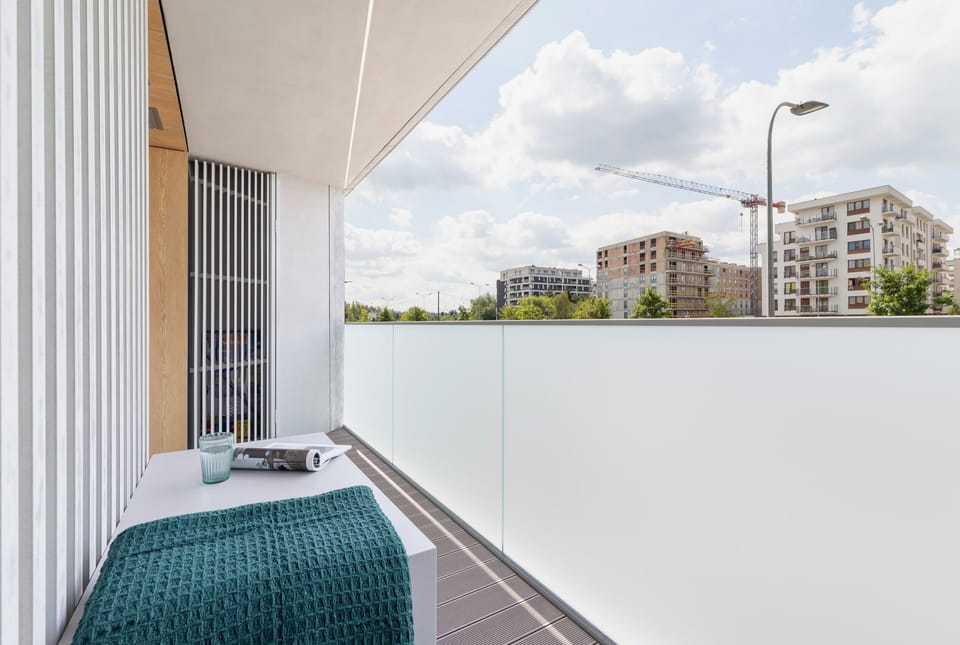 The furnished balcony offers a perfect spot for morning coffee with a view.