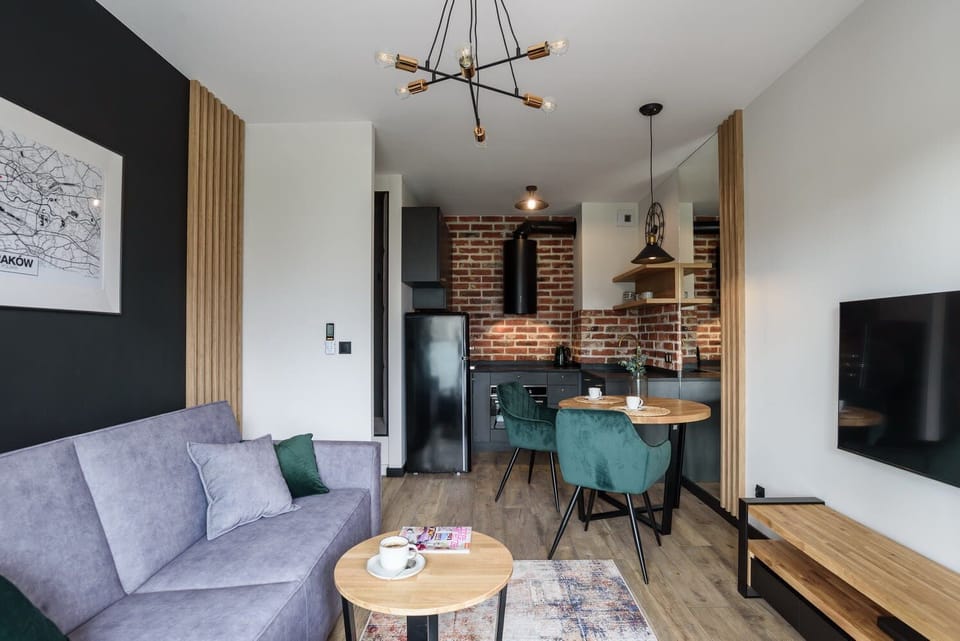 The elegant living room featuring a double sofa bed and dining table.