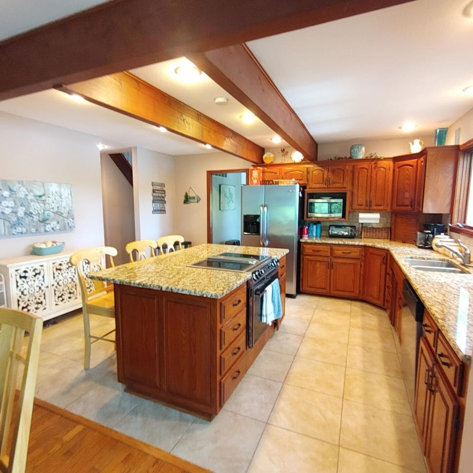 Large kitchen with convection oven and island seating.  Full size refrigerator. 
