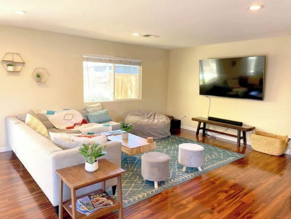 Comfy living space with extra large bean bag and 75" TV