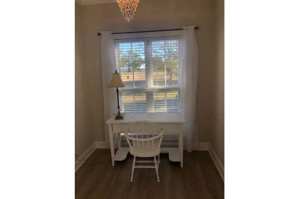 Desk area with 27" monitor and printer.