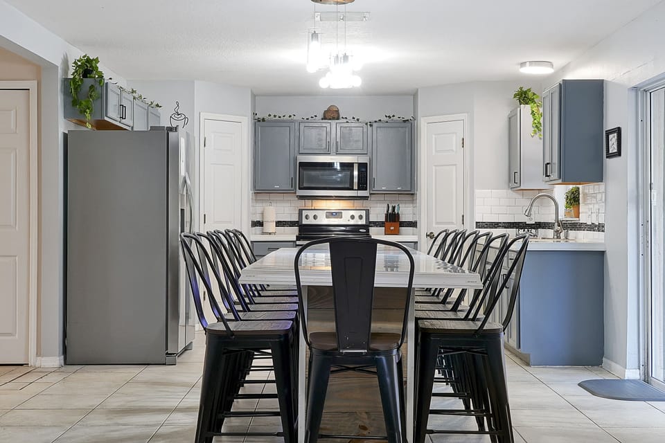 Spacious kitchen with custom-built 12-ft island countertop and bar style stools