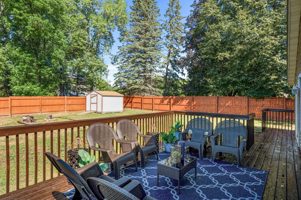Backyard with a fire pit and a deck.