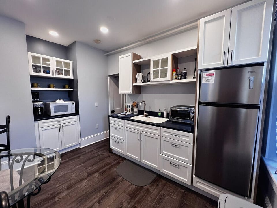 Kitchen equipped with microwave, toaster oven and coffee pot
